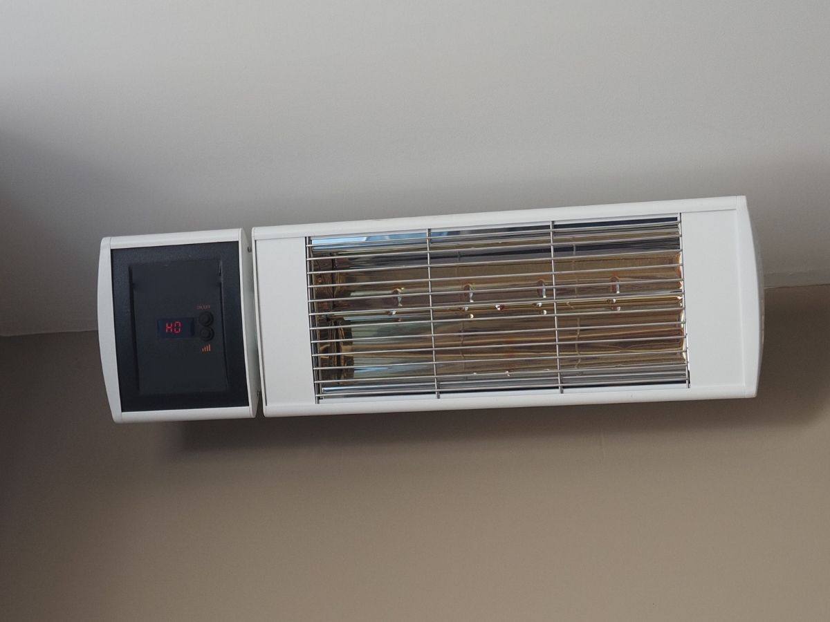 Electric infrared heater mounted on a garage wall
