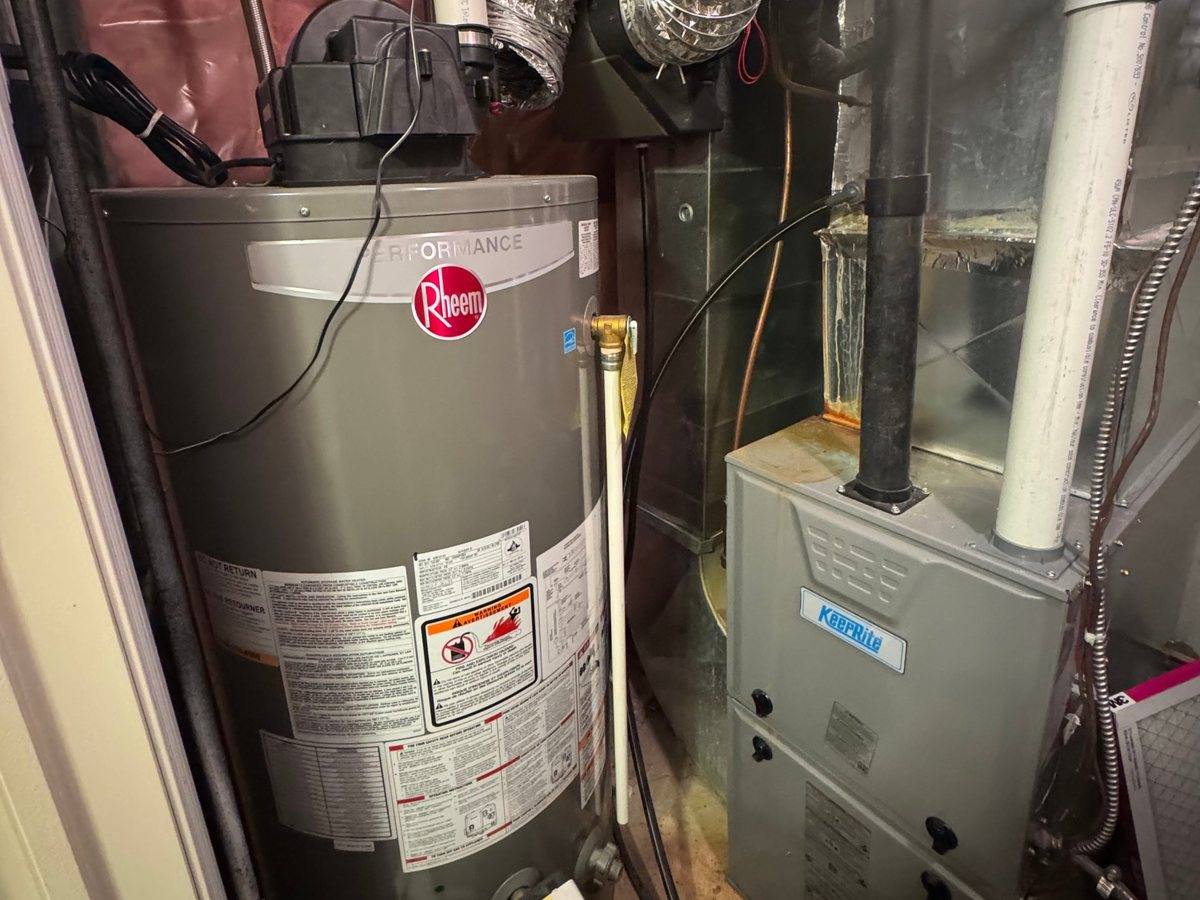 Gas water heater and high efficiency furnace installed by Franklin Heat & Cool in a home utility closet