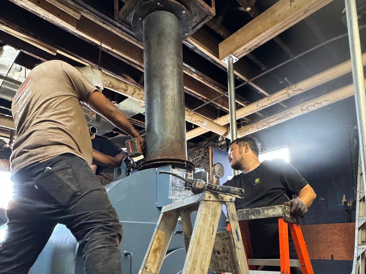 Franklin Heat & Cool technicians installing a boiler flue